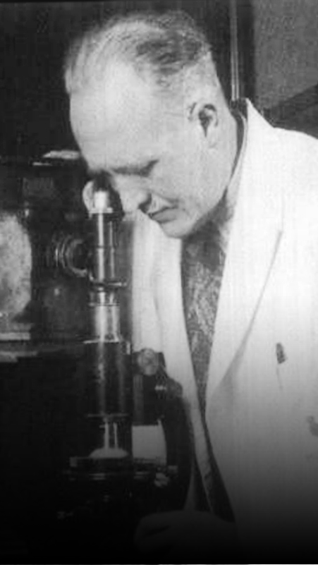 J.C. Mol with microscope