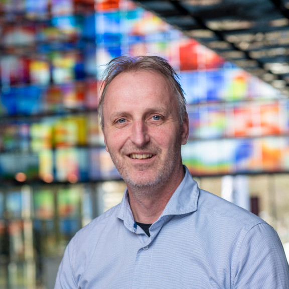 Bas Agterberg in front of colored windows