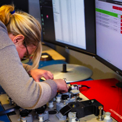 A researcher hanging over an editing table